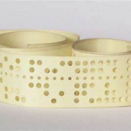 a roll of white tape with holes named punched tape